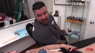 Busty beauty toys around during a tattoo session