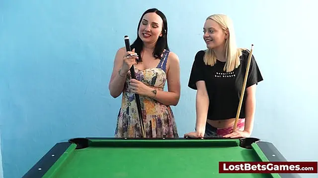 A big tits lesbian couple playing billiard and using the stick in a new way